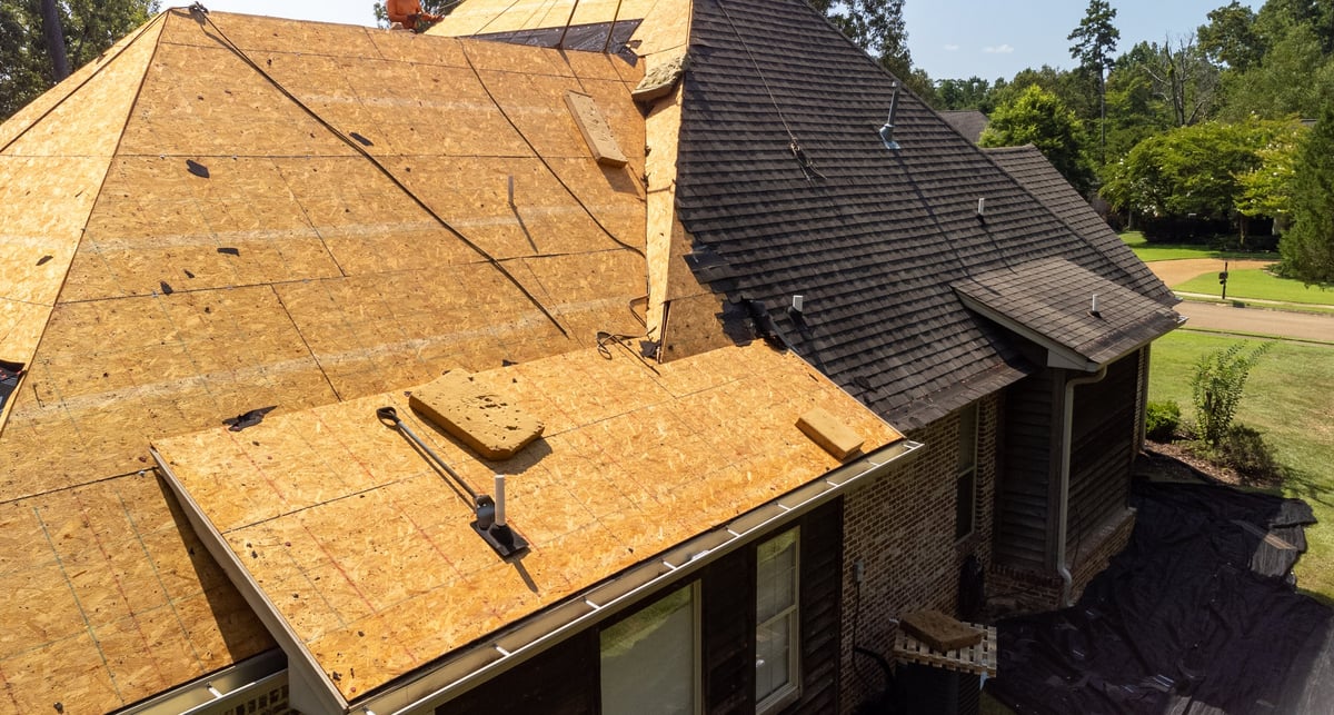 House with brand new roof just installed, complete shingle replacement after storm damage, professional result
